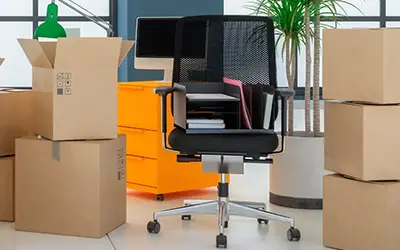 Moving crew organizing office supplies and files for efficient relocation
