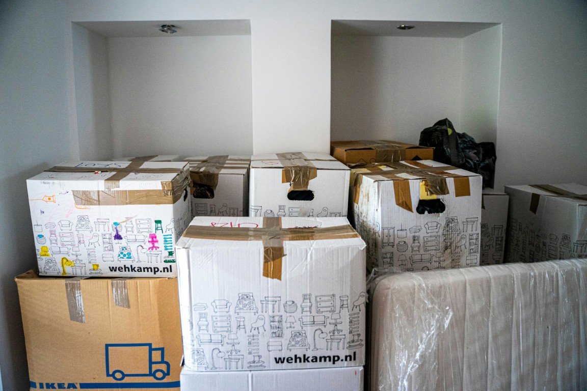 Packed moving boxes and wrapped furniture prepared for interstate moving in La Jolla, CA