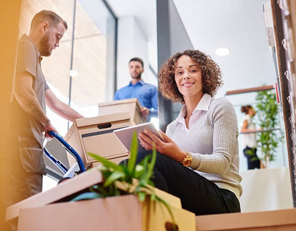 Professional team moving office desks and electronics with expert precision