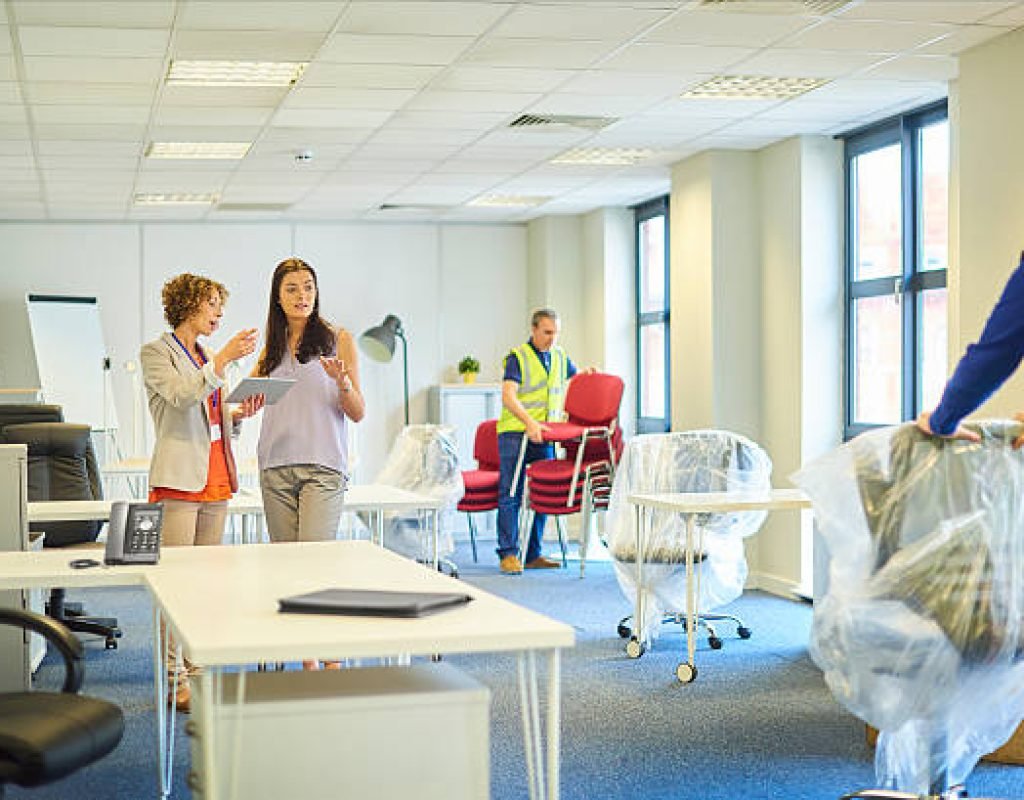 Reliable commercial movers packing business equipment securely for safe delivery