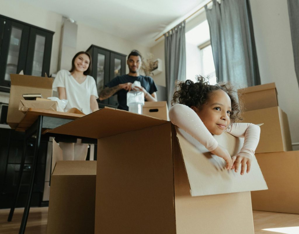 Professional movers wrapping furniture inside a residential home