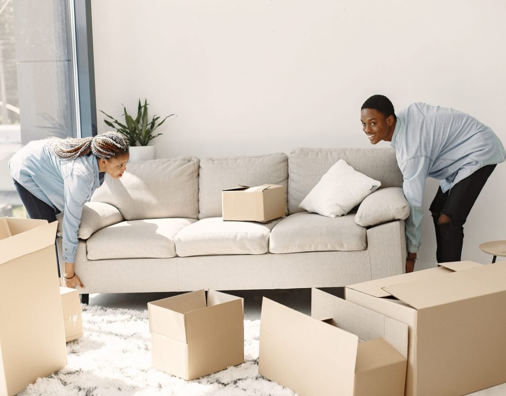 Movers carefully packing household items in boxes for a long distance move